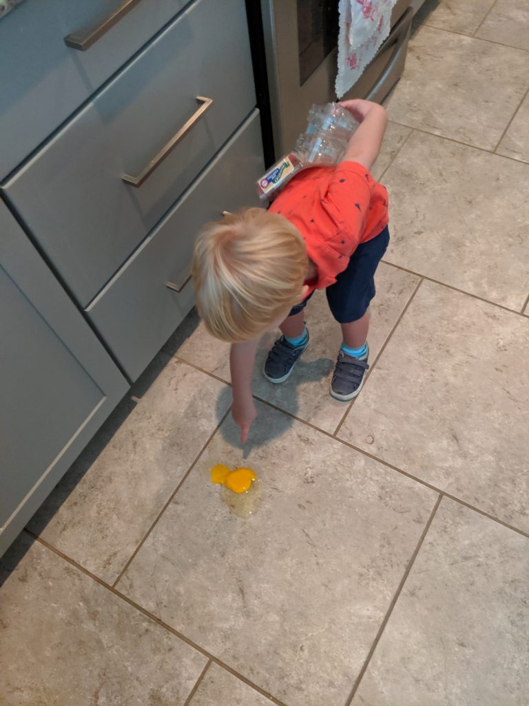 toddler and broken egg
